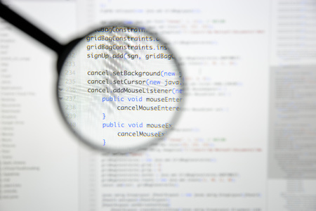 Real Java code developing screen. Programing workflow abstract algorithm concept. Lines of Java code visible under magnifying lens.の写真素材