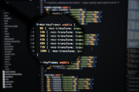 Real css code developing screen. Programing workflow abstract algorithm concept. Lines of css code visible under magnifying lens.の写真素材