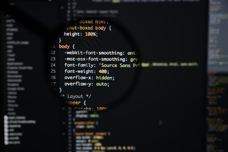 Real css code developing screen. Programing workflow abstract algorithm concept. Lines of css code visible under magnifying lens.の写真素材