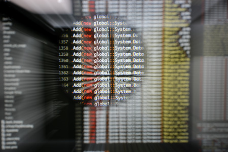 Real c# code developing screen. Programing workflow abstract algorithm concept. Lines of c# code visible under magnifying lens  with moviment effect.の写真素材