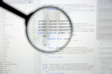 Real c# code developing screen. Programing workflow abstract algorithm concept. Lines of c# code visible under magnifying lens.の写真素材