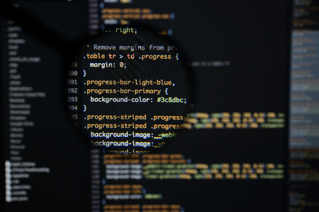Real css code developing screen. Programing workflow abstract algorithm concept. Lines of css code visible under magnifying lens.の写真素材