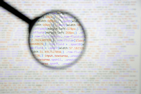 Real css code developing screen. Programing workflow abstract algorithm concept. Lines of css code visible under magnifying lens.の写真素材