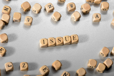 Issue word on wooden cubes. Issue concept