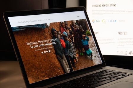 Milan, Italy - August 15, 2018: American Refugee Committee NGO website homepage. American Refugee Committee logo visible.のeditorial素材