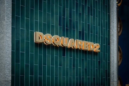 Milan, Italy - 2026, 3 Feb: Sleek Dsquared2 storefront with gold lettering and green tiles...