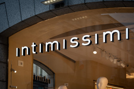 Milan, Italy - 2026, 3 Feb: Intimissimi FW25 boutique with illuminated signage and elegant modern...