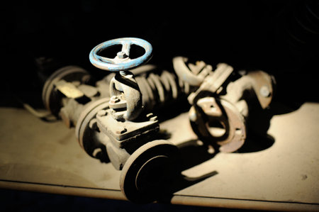 Old steel and iron heavy industrial metal parts and gear in an old factory or workshop for vintage...