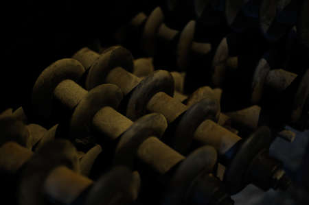 Old steel and iron heavy industrial metal parts and gear in an old factory or workshop for vintage technology used in metallurgy and metalworking and machine productionの写真素材