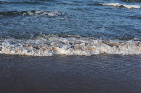 Turquoise sea water waves with horizon and blue sky on a sunny day at the seaside coast of Baltic...