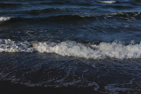 Turquoise sea water waves with horizon and blue sky on a sunny day at the seaside coast of Baltic...