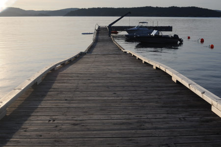 Wooden pier or deck in a calm sea before sunset