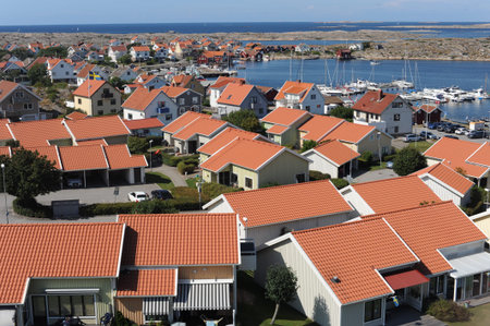 Red tile roofs of houses in SmÃ¶gen town with waterfront in SotenÃ¤s, VÃ¤stra GÃ¶taland,...