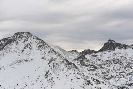 Pyrenees mountains range in winter with snowy peaks in Grandvalira ski paradise resort in Andorraの写真素材