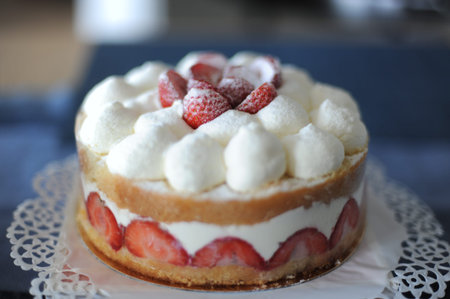A delicious white and red strawberry and whipped cream cake for birthday and wedding with decoration