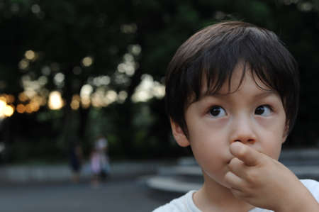 Portrait of a young boy with beautiful eyes in summerの写真素材