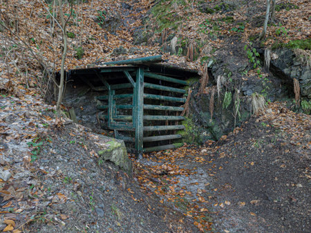 Iron gate at the entrance to an old mine or pit in the mountains