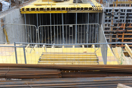 Construction site with concrete and steel structures of a building as an example of civil...