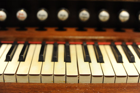 Piano keys or keyboard of old, historic clavichord or harpsichord. Close-up photo with selective focus and shallow depth of fieldの写真素材