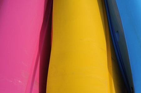 Closeup photo with selective focus of colorful plastic tubes stacked in a rowの写真素材