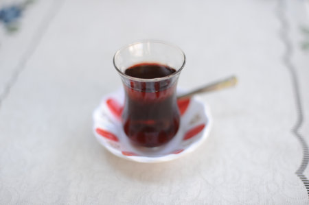 Traditional Turkish black tea in a tulip shaped glass on a table in TÃ¼rkiye (Turkey)の写真素材