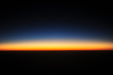 Twilight and dawn at sunrise with clear sky and clear horizon lineの写真素材