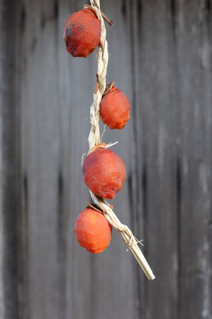 Persimmon or kaki fruits drying outdoors for winter comfort food in Asiaの写真素材
