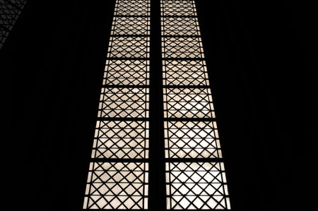 Black and white image of a window with an ornamental lattice pattern in an old churchの写真素材
