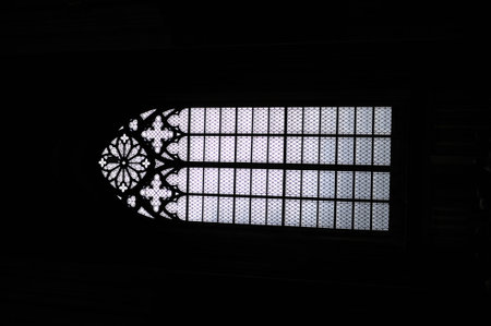 Black and white image of a window with an ornamental lattice pattern in an old churchの写真素材
