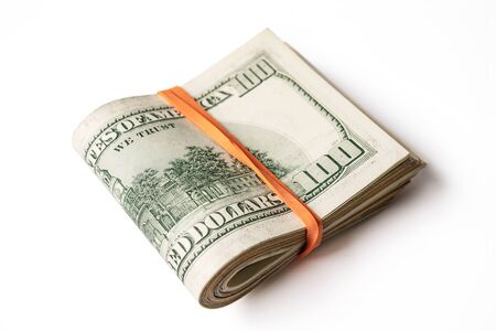 Dollar banknotes rolled into a roll on a white backgroundの写真素材