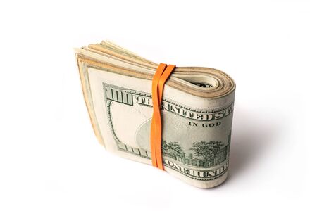 Dollar banknotes rolled into a roll on a white backgroundの写真素材