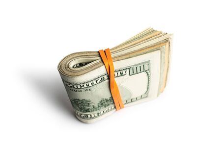 Dollar banknotes rolled into a roll on a white backgroundの写真素材