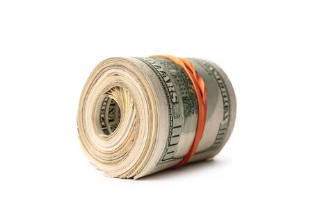 Dollar banknotes rolled into a roll on a white backgroundの写真素材