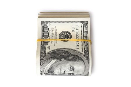 Dollar banknotes rolled into a roll on a white backgroundの写真素材