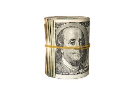 Dollar banknotes rolled into a roll on a white backgroundの写真素材