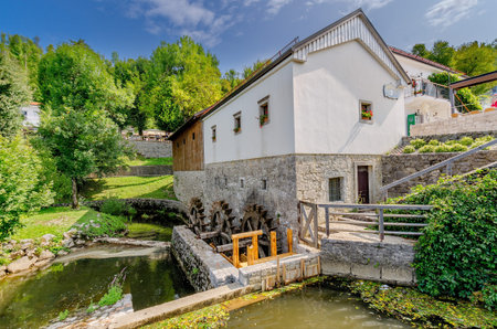 Postojna, Notranjska, Slovenia - August 22, 2017: Modrijan homestead, old mill at Postojna Cave park.のeditorial素材