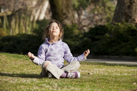 girl in meditation, yoga pose in a parkの写真素材