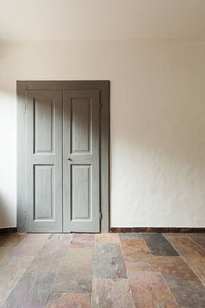 closed door in a rustic house, stone floorの写真素材