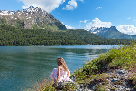 girl on the shore of a mountain lake