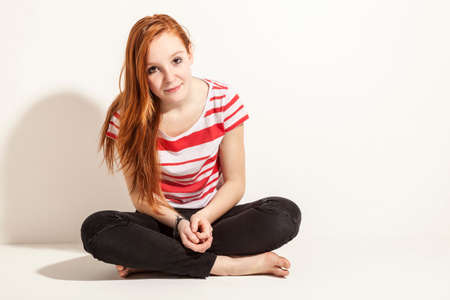 portrait of young beautiful redheaded woman, isolated on white の写真素材