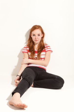 portrait of cute redheaded girl, wall backgroundの写真素材