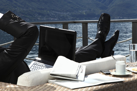 one businessman are relax in front of the lakeの写真素材