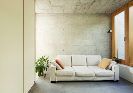 beautiful modern house in cement, interiors, room with divanの写真素材