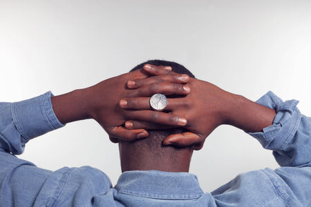 African man with arms crossed behind his back, conceptの写真素材