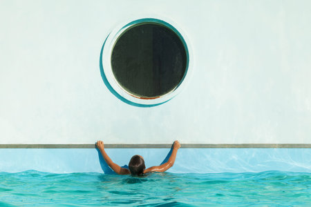 child climbs on the edge of the pool, outdoor