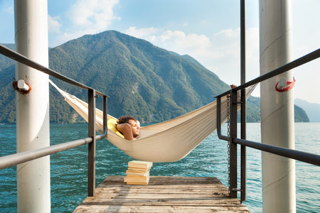 portrait of young man on the dock of Lakeの写真素材