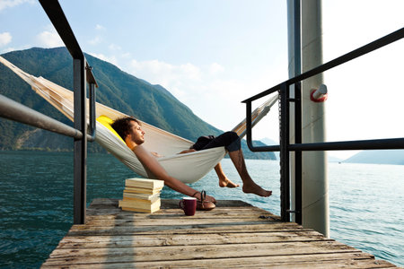 portrait of young man on the dock of Lakeの写真素材