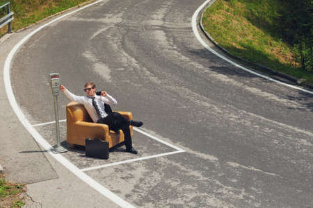 scene of businessmen who parks his armchair and pay the parkingの写真素材