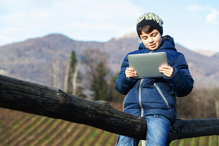 child play with her tablet in outdoorの写真素材