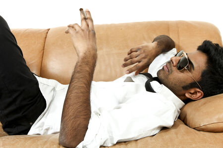 man lying on the leather sofaの写真素材